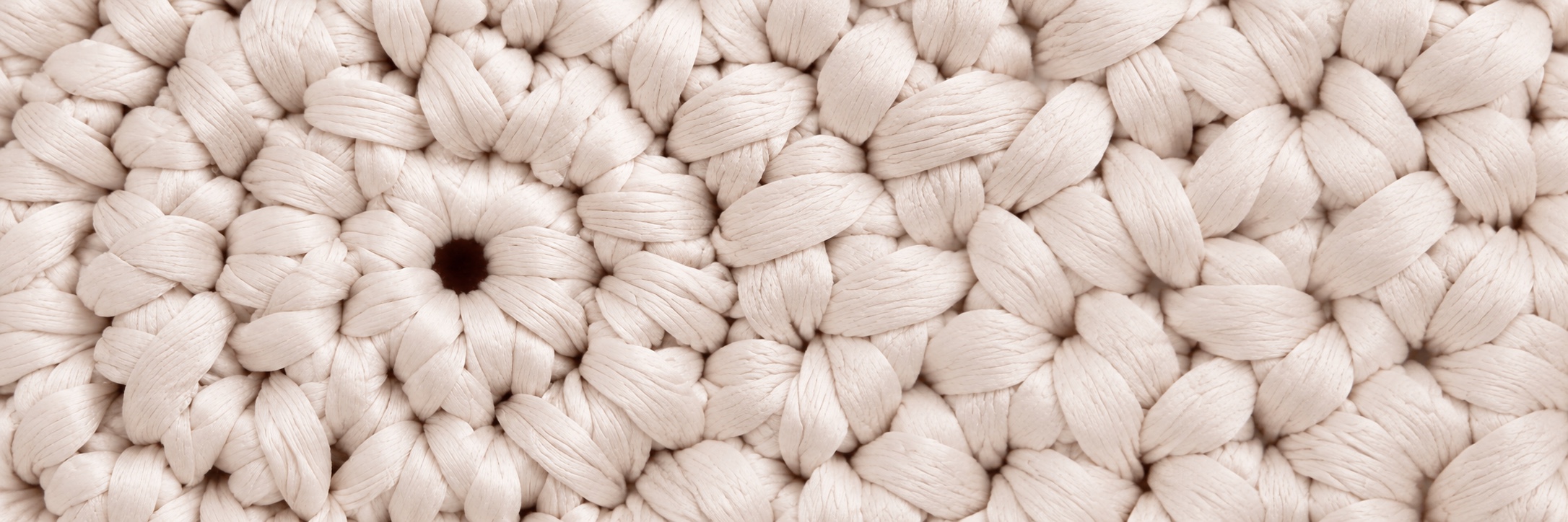 Close-up of pearl white, centre-out crochet texture